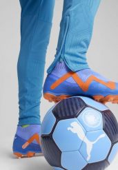 Męskie spodnie treningowe Manchester City PUMA Magic Blue Yellow Glow. Niebieskie spodnie sportowe męskie Puma, na jesień, m, bez wzorów, do piłki nożnej. Za 262.70 zł.