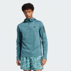 Bluza z kapturem Own The Run Winterized Hooded Half-Zip. Niebieskie bluzy sportowe męskie Adidas, bez zapięcia, do biegania, climawarm (adidas). Za 279.99 zł.