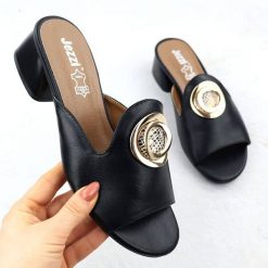 Klapki na klocku z ozdobą czarne Jezzi 214. Czarne klapki damskie Jezzi, z aplikacjami, ze skóry ekologicznej, eleganckie, bez obcasa. Za 113.99 zł.