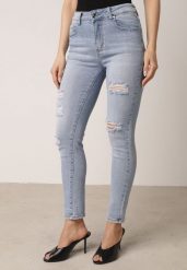 Niebieskie Bawełniane Jeansy o Kroju Slim z Przetarciami Elledima. Niebieskie jeansy damskie Born2be. Za 109.99 zł.