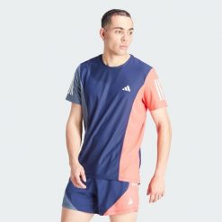 Koszulka Own The Run Colorblock. Czerwone buty sportowe męskie Adidas, z materiału, bez zapięcia, do biegania. W wyprzedaży za 156.75 zł.
