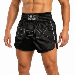 Spodenki tajskie męskie czarne V1 COMBATWEAR DBX Bushido. Czarne krótkie spodenki sportowe męskie DBX BUSHIDO, l, bez wzorów, z żakardem, na fitness i siłownię. Za 239.99 zł.