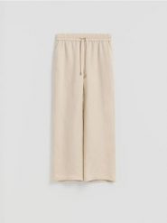 Luźne spodnie z lnem - beżowy. Brązowe spodnie materiałowe damskie Reserved, l, bez wzorów, z wiskozy. Za 129.99 zł.