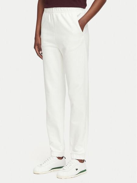 Lacoste Spodnie dresowe XF5268 Kremowy Regular Fit. Białe spodnie dresowe damskie Lacoste, bez wzorów, z dresówki. Za 549.99 zł.
