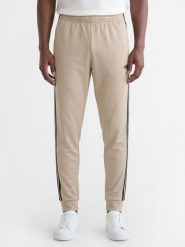 Adidas Originals spodnie do biegania Mężczyźni Sztuczne włókno beżowy, L. Brązowe spodnie sportowe męskie adidas Originals, l, bez wzorów, z bawełny, do biegania. Za 279.95 zł.
