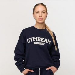 Bluza damska fitness bez kaptura niebieska Varsity. Niebieskie bluzy damskie GYMBEAM, s, bez wzorów, z bawełny, bez kaptura, na fitness i siłownię. Za 139.90 zł.