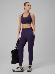 4F Spodnie treningowe szybkoschnące damskie - fioletowe XL. Fioletowe spodnie sportowe damskie 4f, xl, bez wzorów, na fitness i siłownię. Za 179.99 zł.