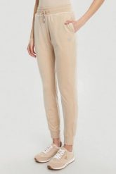 GUESS Beżowe damskie spodnie dresowe Couture, Rozmiar S. Brązowe spodnie dresowe damskie Guess, s, z aplikacjami, z dresówki. W wyprzedaży za 217.99 zł.