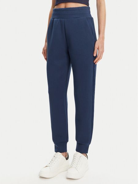 Guess Spodnie dresowe W5YB11 KBYE2 Granatowy Regular Fit. Niebieskie spodnie dresowe damskie Guess, xxl, z aplikacjami, z dresówki. Za 241.99 zł.