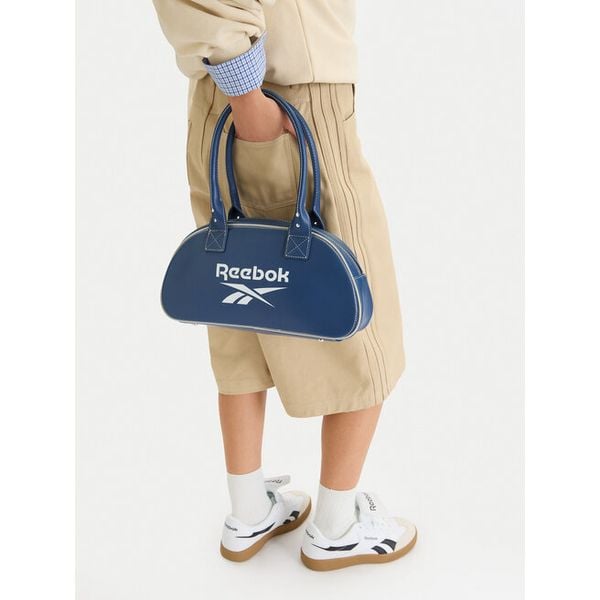 Torebka Reebok. Niebieskie torebki do ręki damskie Reebok, bez wzorów, klasyczne, bez dodatków. Za 90.99 zł.