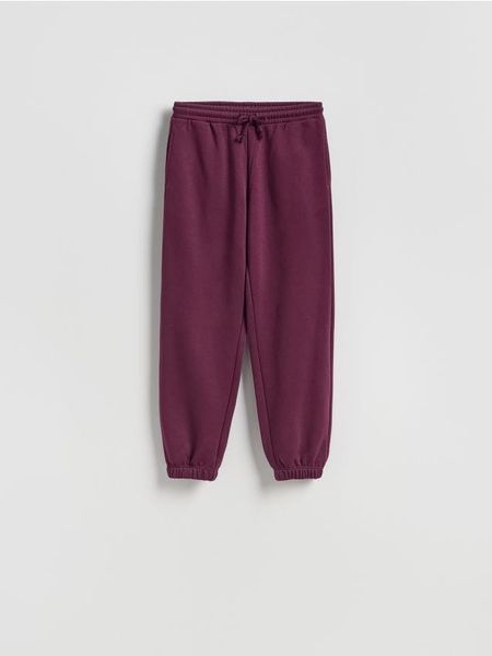 Spodnie dresowe ze ściągaczem - ciemnofioletowy. Fioletowe spodnie dresowe damskie Reserved, l, bez wzorów, z bawełny. Za 99.99 zł.