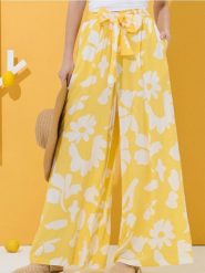 Spodnie wide leg w kwiatowy wzór - żółty. Żółte spodnie materiałowe damskie Sinsay, l, bez wzorów. Za 39.99 zł.