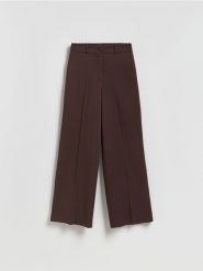 Szerokie spodnie z kantem - brązowy. Brązowe spodnie materiałowe damskie Reserved, l, bez wzorów, z tkaniny. Za 99.99 zł.