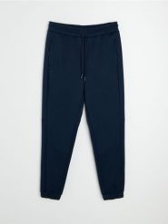 Spodnie tapered fit Active - granatowy. Niebieskie spodnie sportowe męskie Sinsay, l, bez wzorów, na fitness i siłownię. Za 59.99 zł.