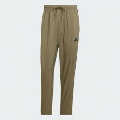 Spodnie Essentials 3-Stripes Stanford Open Hem. Brązowe buty sportowe męskie Adidas, l, bez wzorów, z materiału, na fitness i siłownię. Za 179.00 zł.