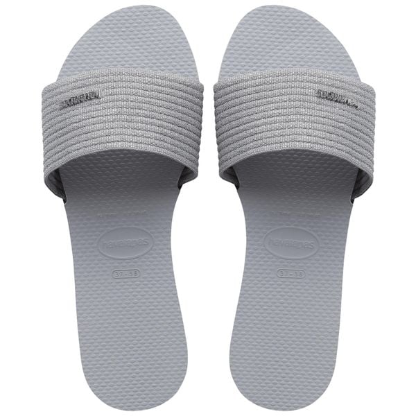 Klapki Havaianas Model 4147312 Kolor Szary. Szare klapki damskie Havaianas, bez wzorów, z materiału, eleganckie, bez obcasa. Za 179.99 zł.