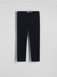 Bawełniane spodnie slim fit - czarny. Czarne spodnie materiałowe męskie Reserved, l, bez wzorów, z bawełny. W wyprzedaży za 89.99 zł.