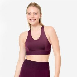 Stanik sportowy Decathlon. Fioletowe bluzy sportowe damskie DOMYOS, s, bez wzorów, z elastanu, bez kaptura, na jogę i pilates. W wyprzedaży za 49.99 zł.