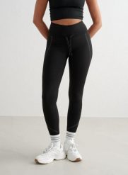Damskie legginsy, wysoki stan, odprowadzające pot, odblaskowe, ocieplane czarne. Czarne legginsy damskie Aim'n, s, bez wzorów, z elastanu. Za 247.65 zł.