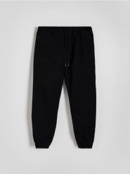 Spodnie jogger slim - czarny. Czarne spodnie materiałowe męskie Reserved, l, bez wzorów, z bawełny. Za 129.99 zł.