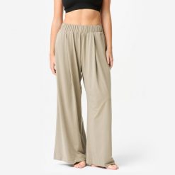 Spodnie do jogi i pilatesu damskie Domyos Retreat. Brązowe spodnie sportowe damskie Decathlon, l, bez wzorów, z materiału, na fitness i siłownię. Za 129.99 zł.