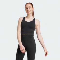 Koszulka na ramiączkach All Me z wbudowanym biustonoszem o średnim wsparciu. Czarne koszulki sportowe damskie Adidas, m, bez wzorów, z elastanu, bez kołnierzyka, bez ramiączek, na fitness i siłownię. Za 219.00 zł.