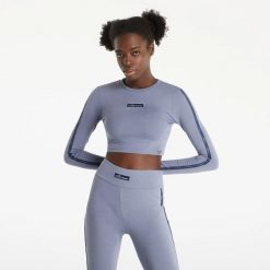 KOSZULKA DAMSKA Z DŁUGIM RĘKAWEM BLUZKA CROP ELLESSE. Czarne koszulki sportowe damskie Ellesse, s, bez wzorów, z bawełny, bez kołnierzyka, bez ramiączek, na fitness i siłownię. Za 156.00 zł.