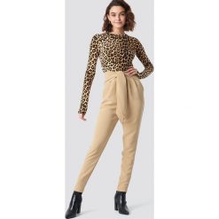NA-KD Eleganckie spodnie z wiązaniem - Beige. Spodnie materiałowe damskie marki NA-KD. W wyprzedaży za 64.78 zł.