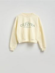 Bluza oversize z nadrukiem - kremowy. Białe bluzy damskie Reserved, l, bez wzorów, z bawełny, bez kaptura. W wyprzedaży za 49.99 zł.