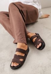 Brązowe Płaskie Klapki z Ozdobnymi Wycięciami i Paskiem na Rzep Hisine. Brązowe klapki damskie Born2be, bez wzorów, z jeansu, eleganckie, bez obcasa, na płaskiej podeszwie. Za 69.99 zł.