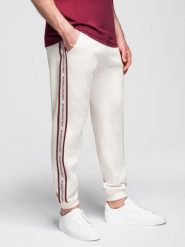 Sportowe spodnie męskie jogger z lampasami – kremowe V2. Białe spodnie sportowe męskie Ombre Clothing, m, bez wzorów, z bawełny. Za 219.99 zł.