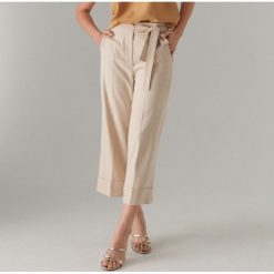 Spodnie culotte z wiązaniem - Beżowy. Brązowe spodnie materiałowe damskie Mohito, bez wzorów. W wyprzedaży za 39.99 zł.