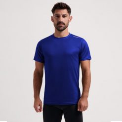 Funkcjonalna koszulka męska Rogelli PROMOTION. Niebieskie koszulki sportowe męskie Rogelli, m, bez wzorów, bez kołnierzyka, bez ramiączek, na fitness i siłownię. W wyprzedaży za 40.00 zł.