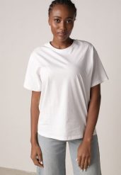 Biały T-shirt z Bawełny Typu Oversize Nedika. Białe bluzki damskie Born2be, m, bez wzorów, z bawełny, klasyczne, bez kołnierzyka, bez ramiączek. Za 39.99 zł.