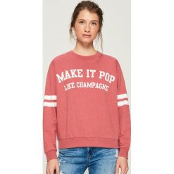 Dzianinowa bluza z nadrukiem - Pomarańczo. Pomarańczowe bluzy damskie marki Sinsay, z nadrukiem, z dzianiny. Za 29.99 zł.