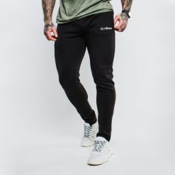Spodnie dresowe męskie fitness slim fit czarne. Czarne spodnie sportowe męskie GYMBEAM, l, bez wzorów, z bawełny, na fitness i siłownię. Za 84.90 zł.