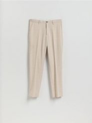 Garniturowe spodnie slim fit - beżowy. Brązowe eleganckie spodnie męskie Reserved, bez wzorów, z tkaniny. Za 169.99 zł.