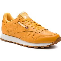 Buty Reebok - Classic Leather Mu DV3841 Trek Gold/White. Żółte półbuty na co dzień męskie Reebok, z materiału, eleganckie, bez zapięcia. W wyprzedaży za 249.00 zł.