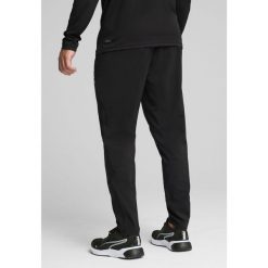 Męskie tkane spodnie TAD ESSENTIALS o zwężanym kroju PUMA Black. Czarne spodnie sportowe męskie Puma, l, bez wzorów, do biegania. Za 229.00 zł.