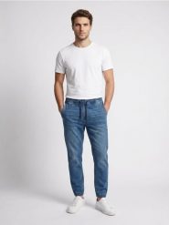 Jeansy jogger slim z efektem sprania - niebieski. Niebieskie jeansy męskie Sinsay. Za 59.99 zł.