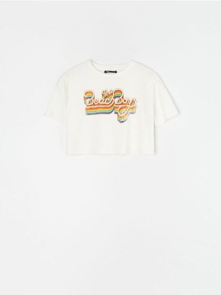 Bawełniana koszulka z nadrukiem The Beach Boys - kremowy. Białe t-shirty damskie Sinsay, l, bez wzorów, z bawełny, bez kołnierzyka. Za 19.99 zł.