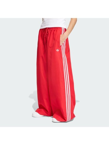 Adidas Spodnie dresowe Firebird Adilenium KD6299 Czerwony Regular Fit. Czerwone spodnie dresowe damskie Adidas, m, bez wzorów, z dresówki. Za 399.99 zł.