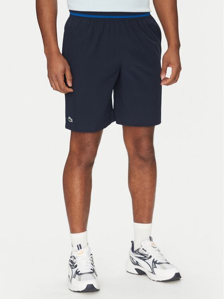 Lacoste Szorty tenisowe GH7413 Granatowy Regular Fit. Niebieskie krótkie spodenki sportowe męskie Lacoste, m, bez wzorów, z syntetyku, tenisowe. Za 399.99 zł.