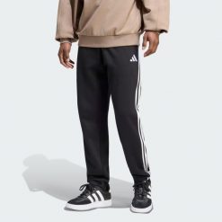 Spodnie Essentials z tkaniny frotté z 3 paskami i zwężanymi nogawkami. Białe spodnie sportowe męskie Adidas, l, bez wzorów, z bawełny. Za 219.00 zł.