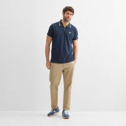 MUNICH VARSITY Niebieski. Niebieskie koszulki polo męskie munich, m, bez wzorów, z tkaniny, bez ramiączek. Za 175.99 zł.