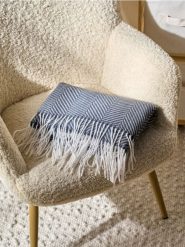 Koc wykończony frędzlami w asymetryczne paski - szary. Szare kocyki dla dzieci Sinsay. Za 27.99 zł.