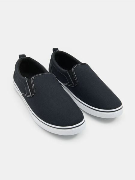 Trampki typu slip-on - czarny. Czarne trampki męskie Sinsay, bez wzorów, bez zapięcia. Za 29.99 zł.