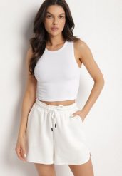 Biały Krótki Tank Top z Prążkowanej Tkaniny Nevallia. Białe bluzki damskie Born2be, l, bez wzorów, z jeansu, eleganckie, bez kołnierzyka, bez ramiączek. Za 29.99 zł.