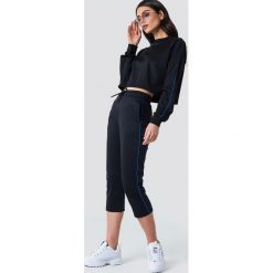 NA-KD Spodnie sportowe - Black. Czarne spodnie sportowe damskie NA-KD, z poliesteru. W wyprzedaży za 70.98 zł.