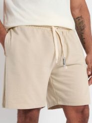 Szorty - beżowy. Brązowe szorty męskie Sinsay, l, bez wzorów, z bawełny, sportowe. Za 29.99 zł.